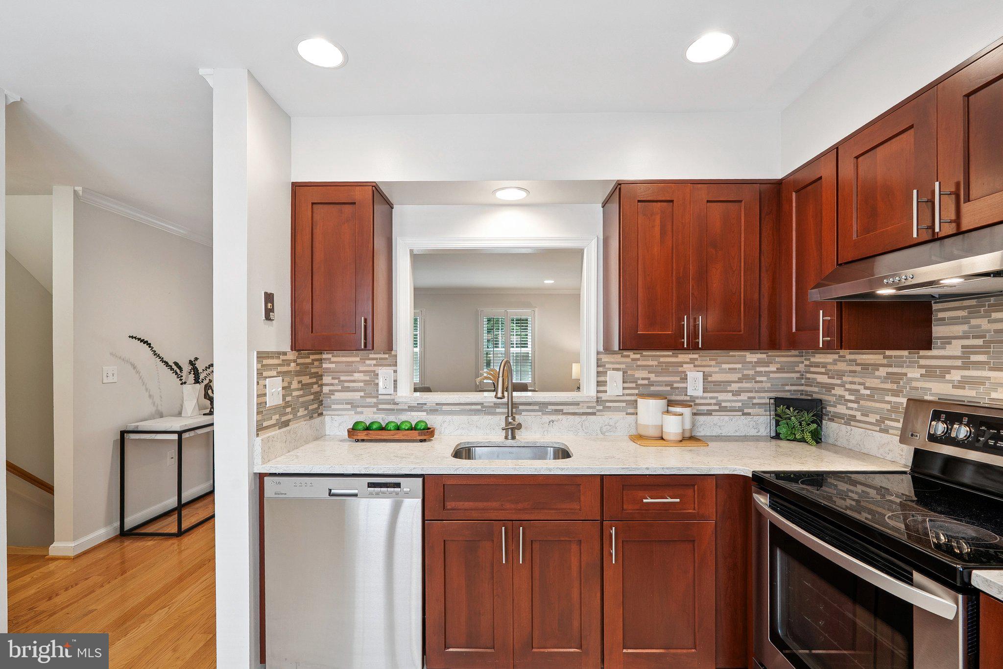 6861 Washington Boulevard Arlington, VA 22213 - Photo 6 of 28 a kitchen with stainless steel appliances granite countertop a sink stove and cabinets