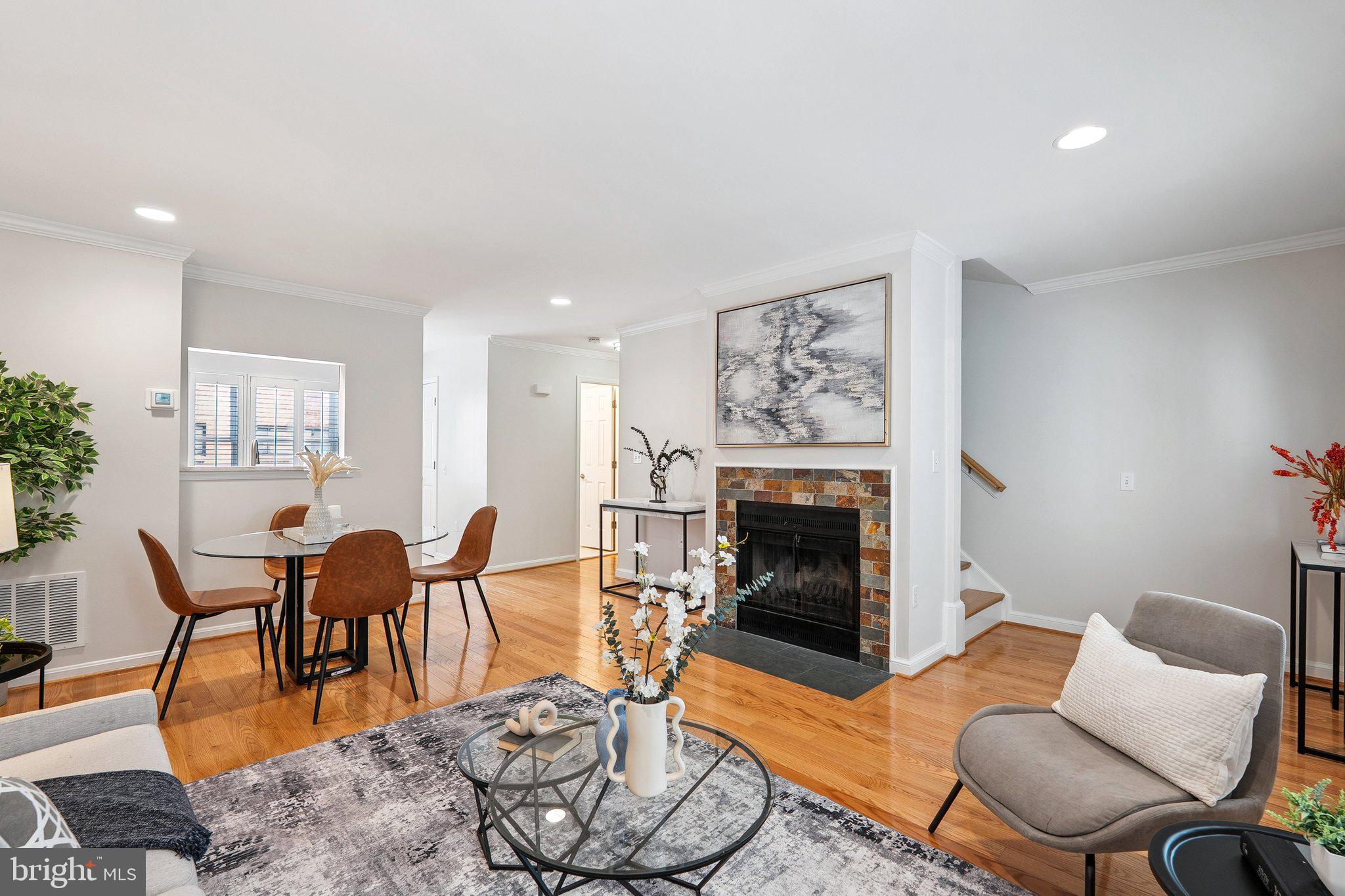 6861 Washington Boulevard Arlington, VA 22213 - Photo 9 of 28 a living room with furniture a dining table and a fireplace