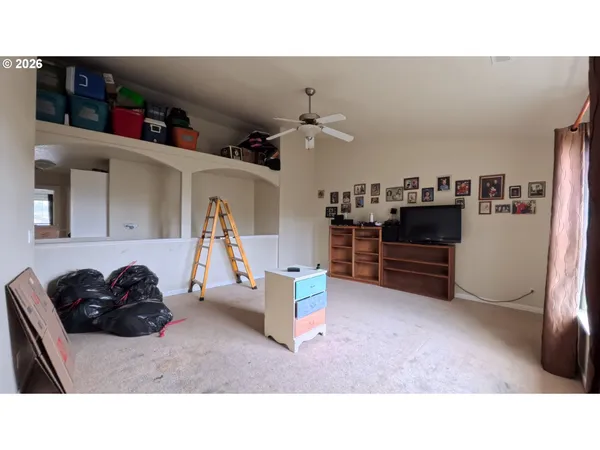 a living room with furniture a kitchen view and appliances
