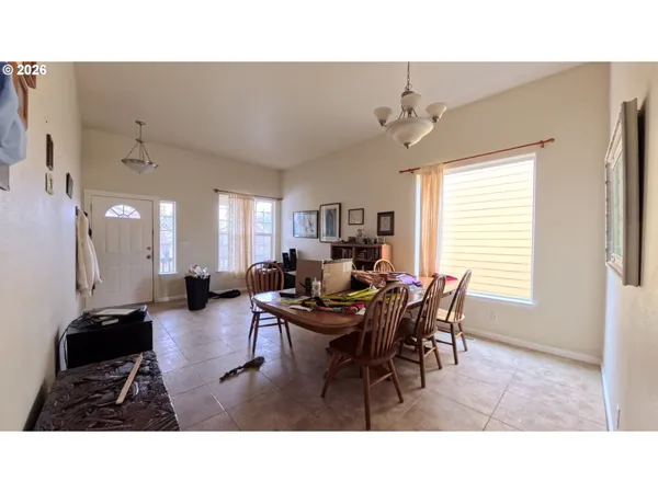 a living room with furniture a flat screen tv and a window