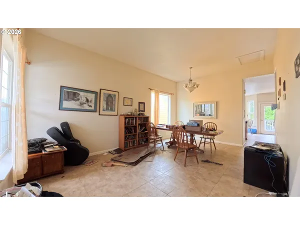 a living room with furniture a flat screen tv and a window