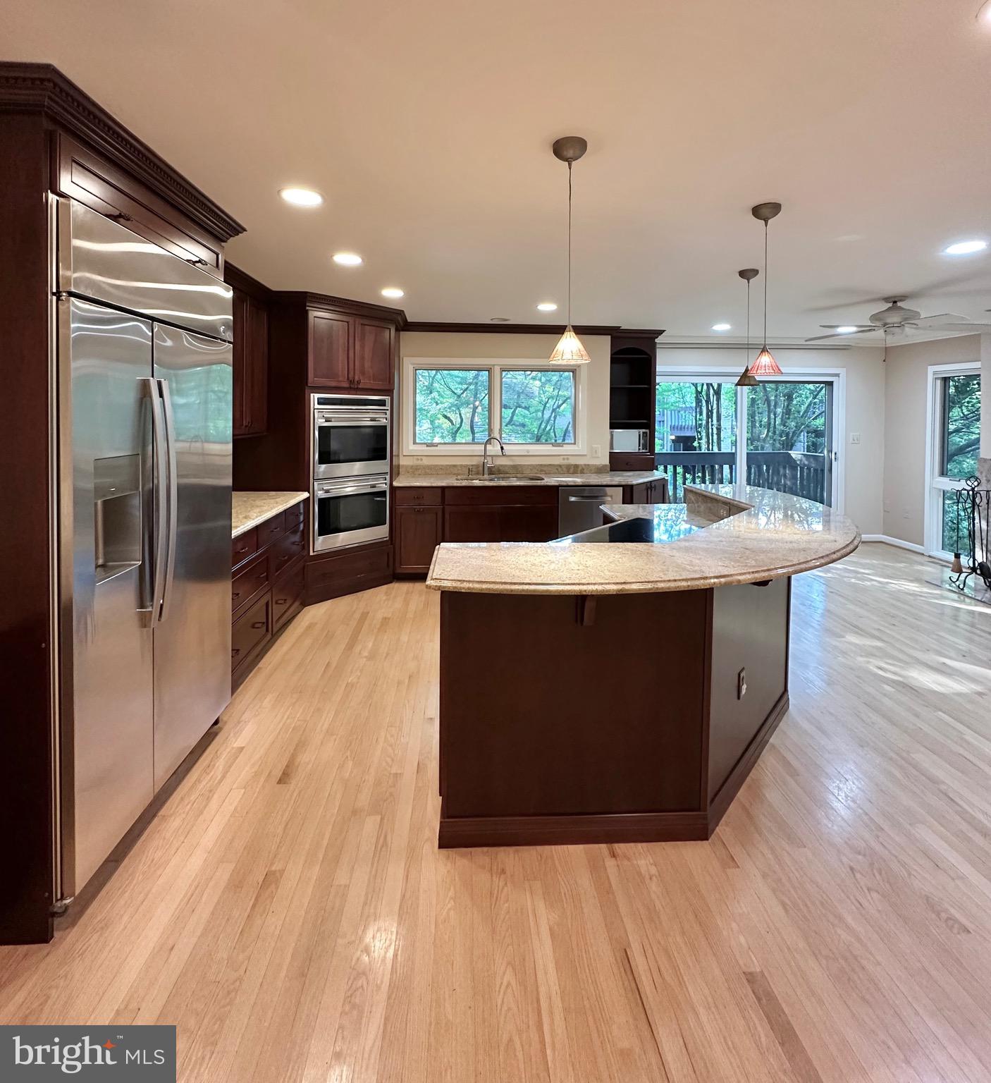 2021 Lakebreeze Way Reston, VA 20191 - Photo 11 of 51 a large room with kitchen island a flat screen tv