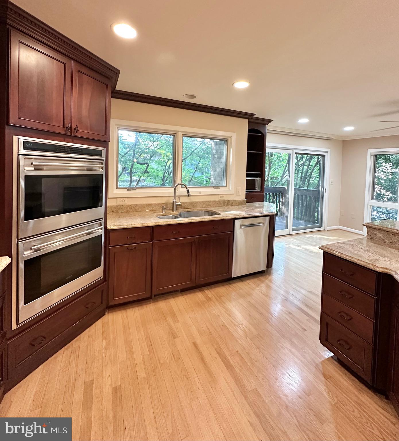 2021 Lakebreeze Way Reston, VA 20191 - Photo 12 of 51 a large kitchen with wooden cabinets and stainless steel appliances