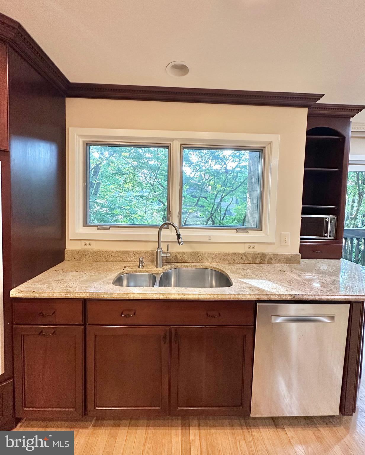 2021 Lakebreeze Way Reston, VA 20191 - Photo 15 of 51 a kitchen with kitchen island granite countertop a sink and a large window