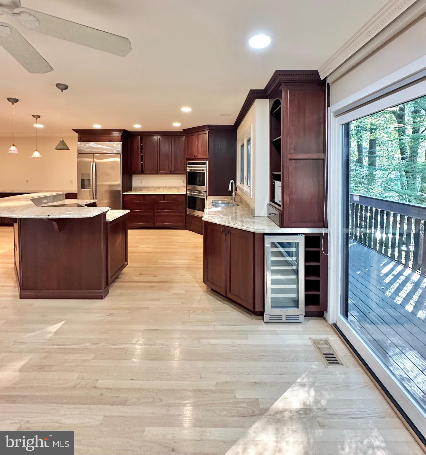 2021 Lakebreeze Way Reston, VA 20191 - Photo 16 of 51 a kitchen with stainless steel appliances kitchen island granite countertop a stove and a sink