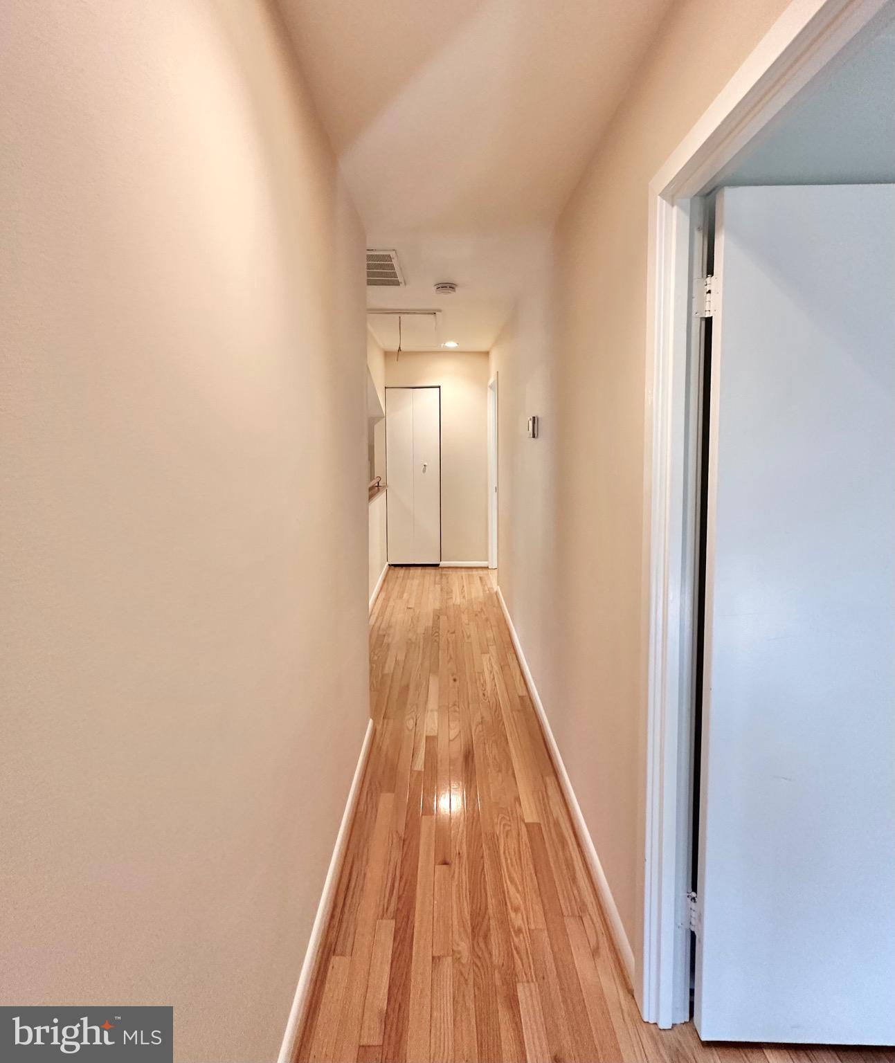 2021 Lakebreeze Way Reston, VA 20191 - Photo 34 of 51 a view of a hallway with wooden floor