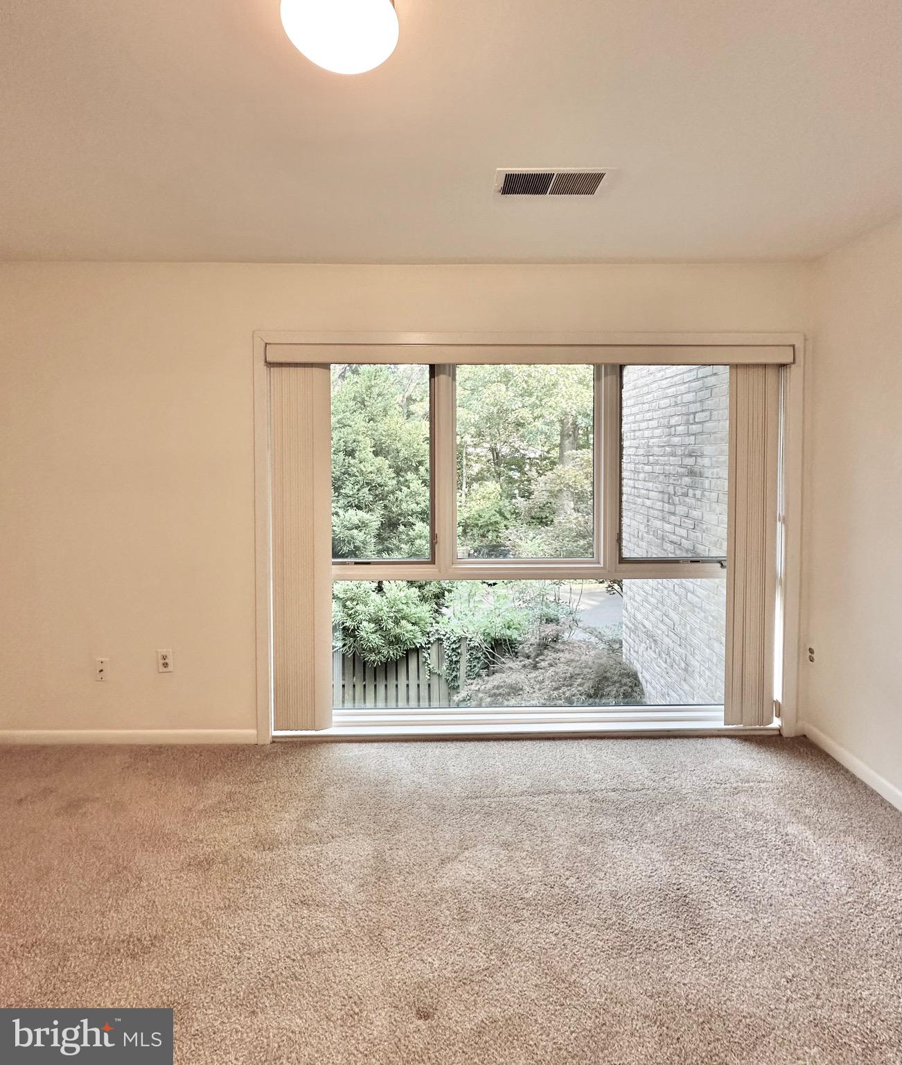 2021 Lakebreeze Way Reston, VA 20191 - Photo 36 of 51 an empty room with wooden floor and windows