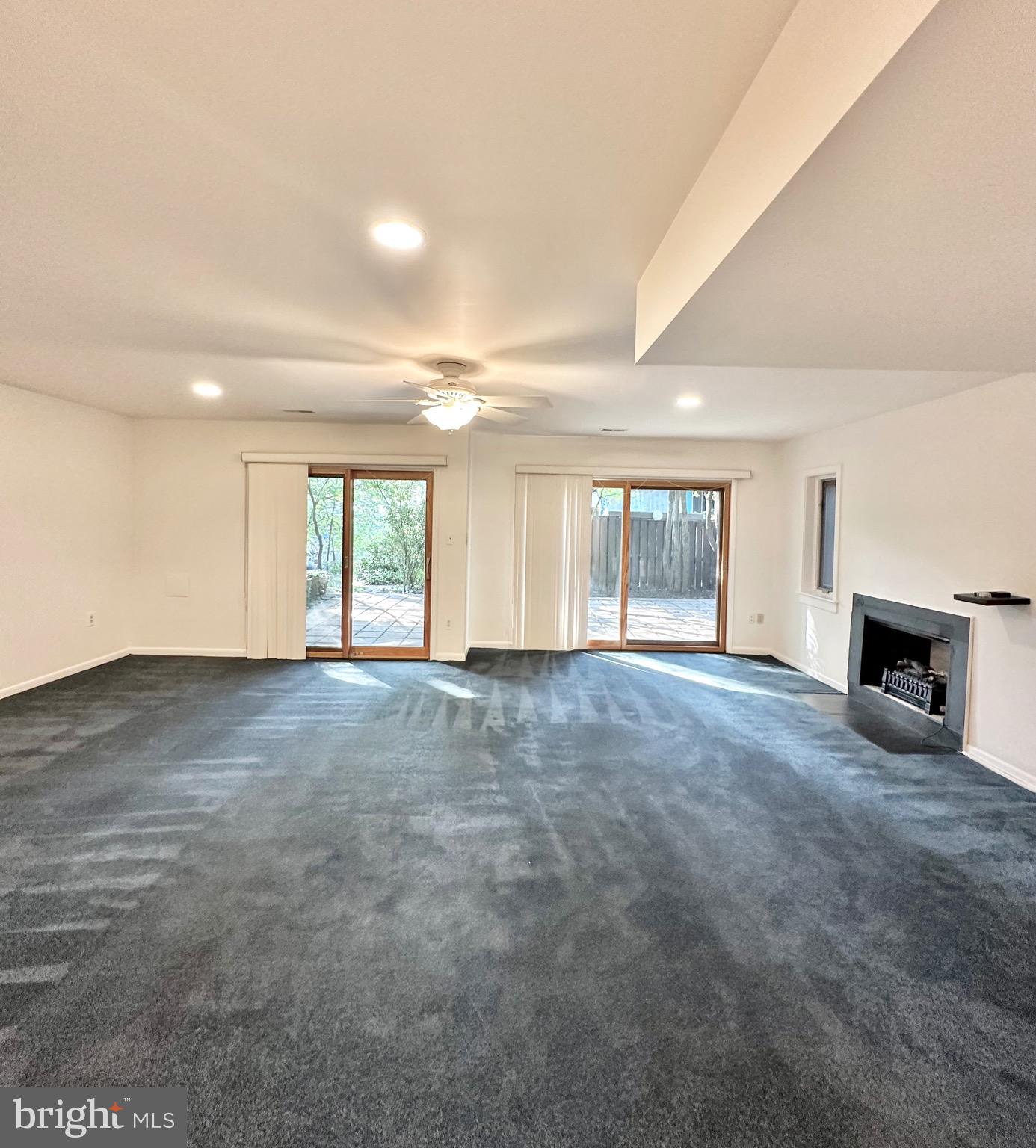 2021 Lakebreeze Way Reston, VA 20191 - Photo 42 of 51 an empty room with windows and a fireplace