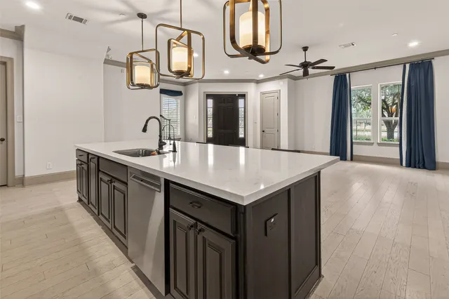a kitchen with cabinets a sink and a stove