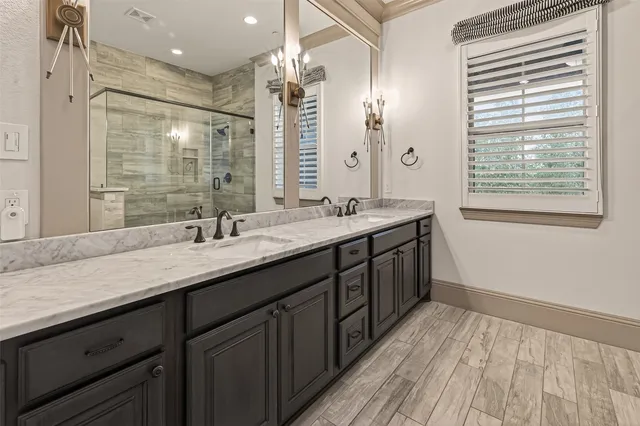 a bathroom with a sink a toilet and shower