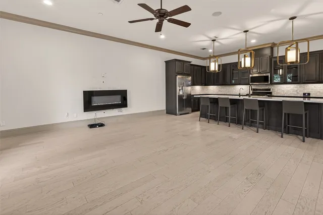 a view of a room with lots of wooden furniture and windows