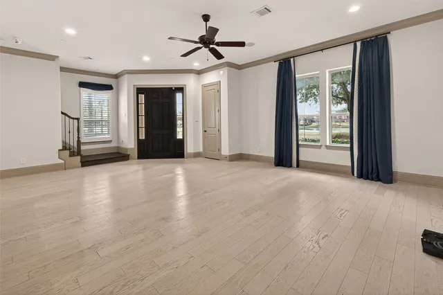 a view of a livingroom with a ceiling fan and window