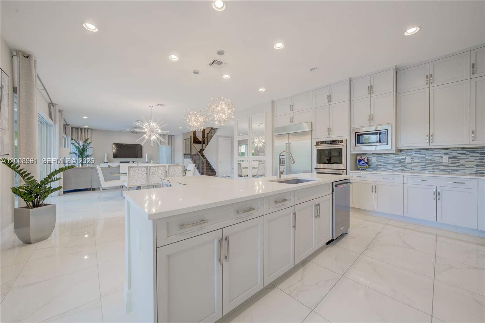 11655 Windy Frst Way Boca Raton, FL 33498 - Photo 11 of 47 a large kitchen with stainless steel appliances lots of counter space sink and cabinets
