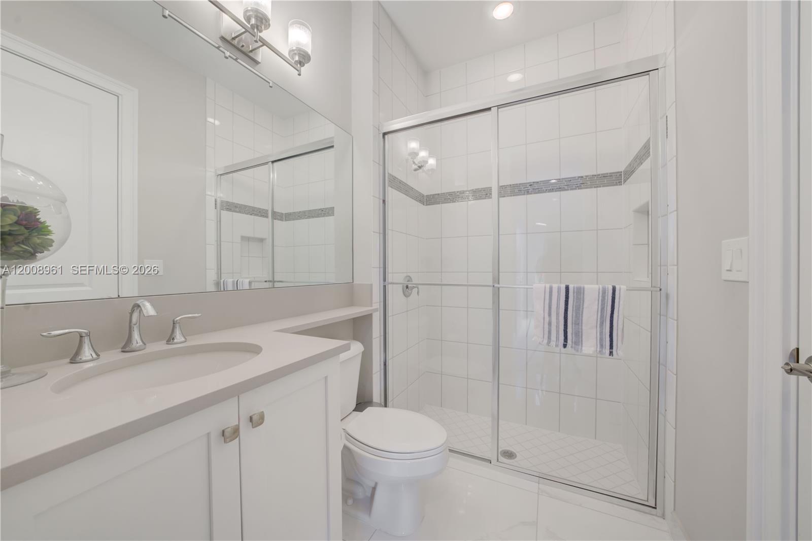 11655 Windy Frst Way Boca Raton, FL 33498 - Photo 19 of 47 a bathroom with a sink toilet vanity and shower