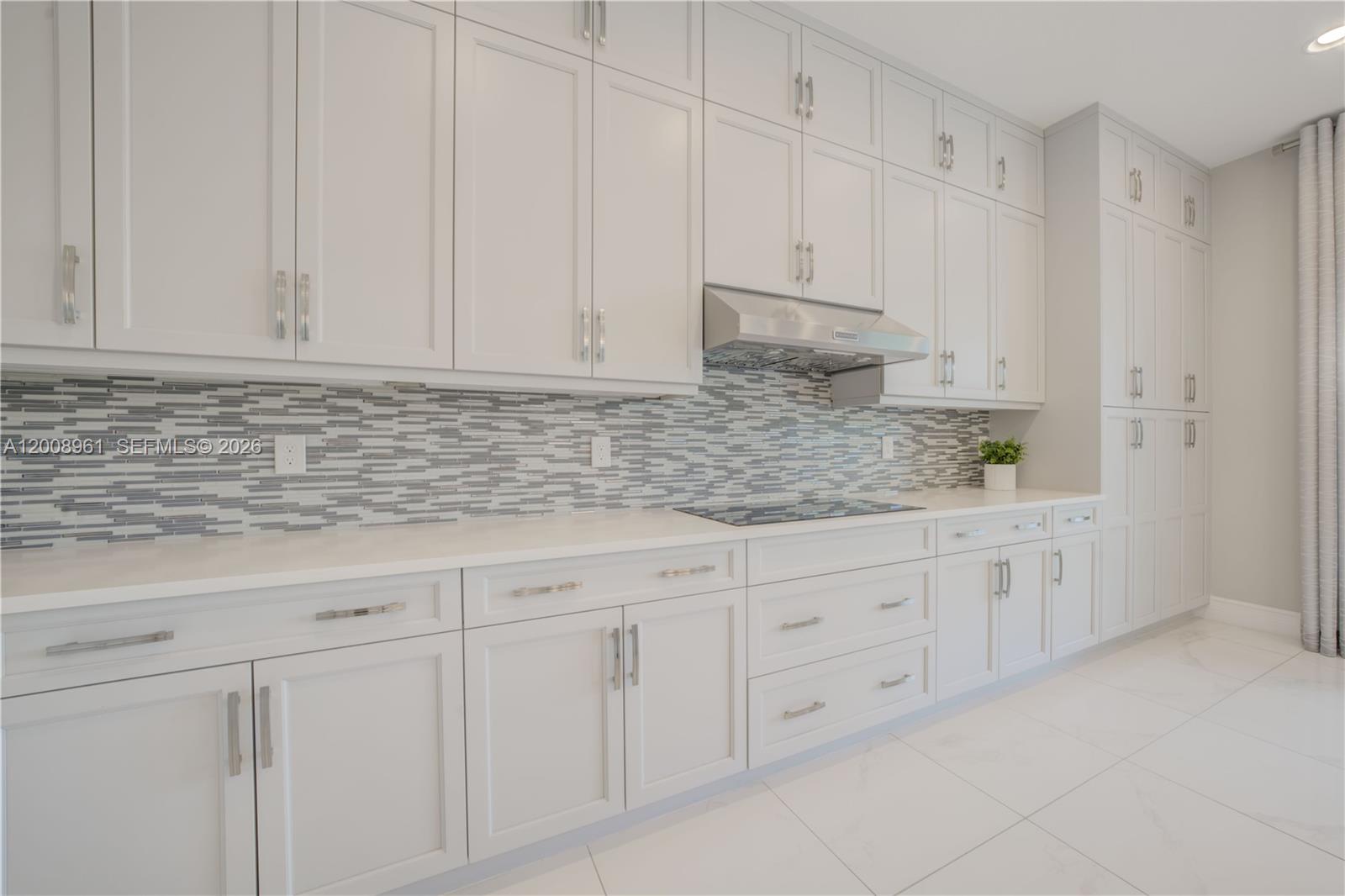 11655 Windy Frst Way Boca Raton, FL 33498 - Photo 23 of 47 a kitchen with white cabinets