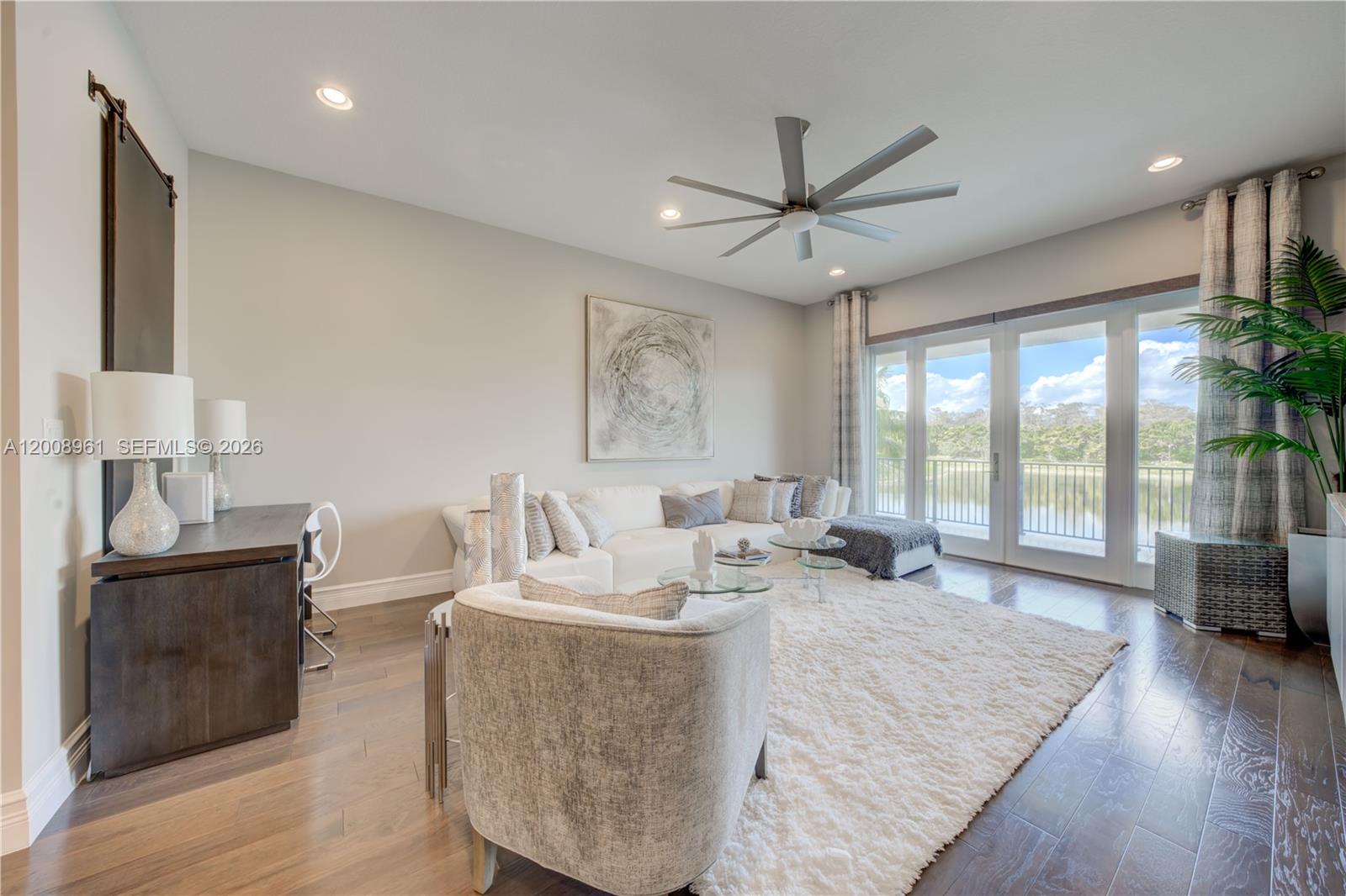 11655 Windy Frst Way Boca Raton, FL 33498 - Photo 25 of 47 a living room with furniture large window and wooden floor