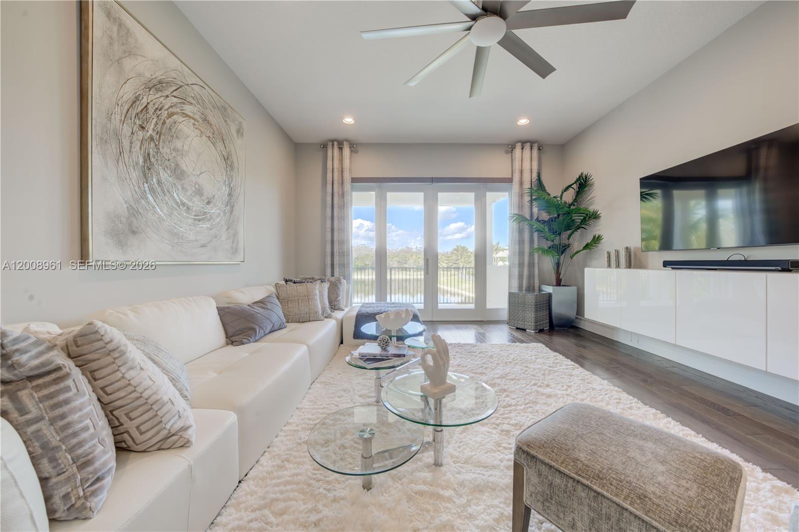 11655 Windy Frst Way Boca Raton, FL 33498 - Photo 26 of 47 a living room with furniture and a flat screen tv