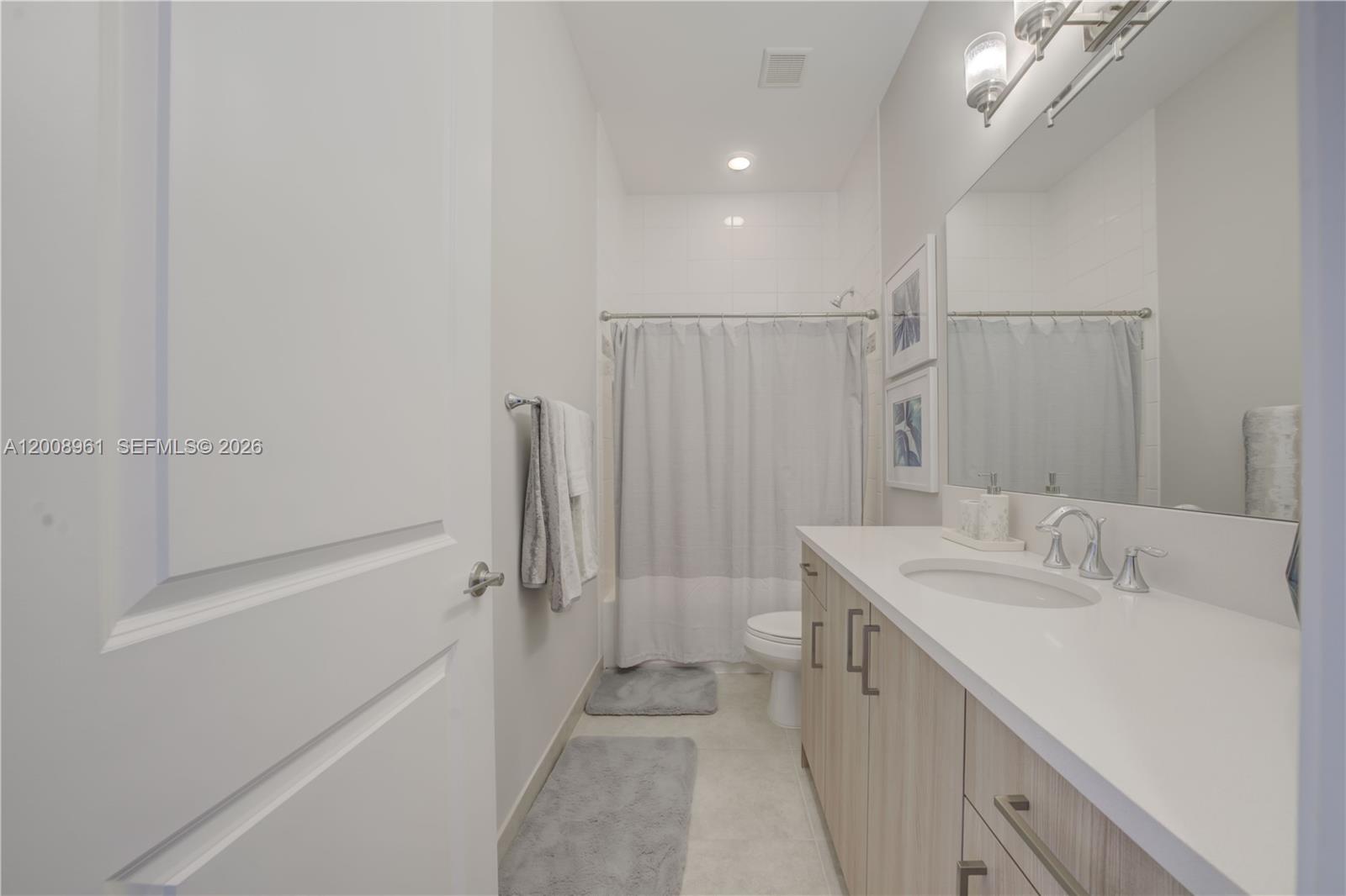 11655 Windy Frst Way Boca Raton, FL 33498 - Photo 32 of 47 a bathroom with a sink a toilet and shower