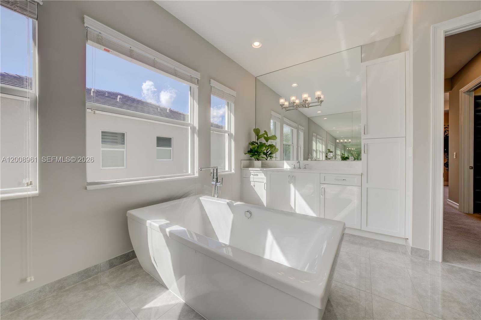11655 Windy Frst Way Boca Raton, FL 33498 - Photo 41 of 47 a bath tub sitting in a bathroom next to a window