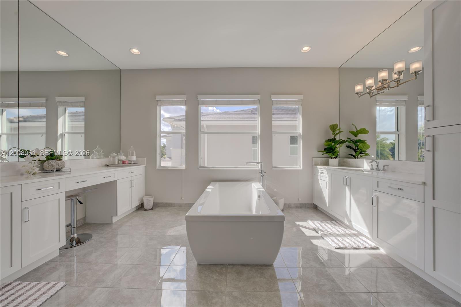 11655 Windy Frst Way Boca Raton, FL 33498 - Photo 43 of 47 a spacious bathroom with a double vanity sink a large mirror and shower