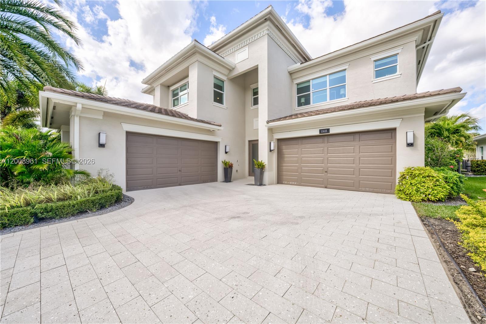 11655 Windy Frst Way Boca Raton, FL 33498 - Photo 47 of 47 a front view of a house with a yard and garage