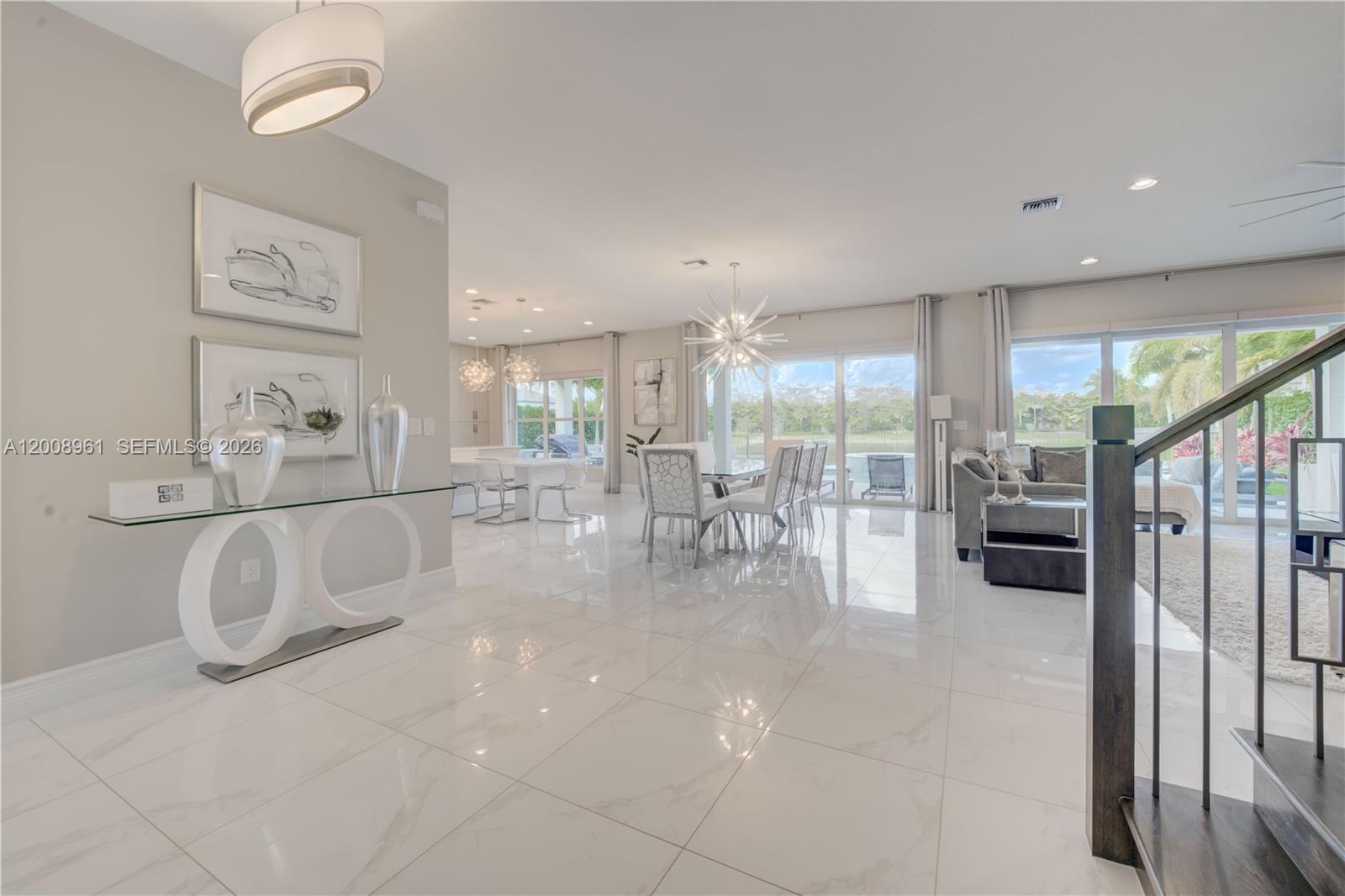 11655 Windy Frst Way Boca Raton, FL 33498 - Photo 5 of 47 a living room with furniture a large window and stainless steel appliances