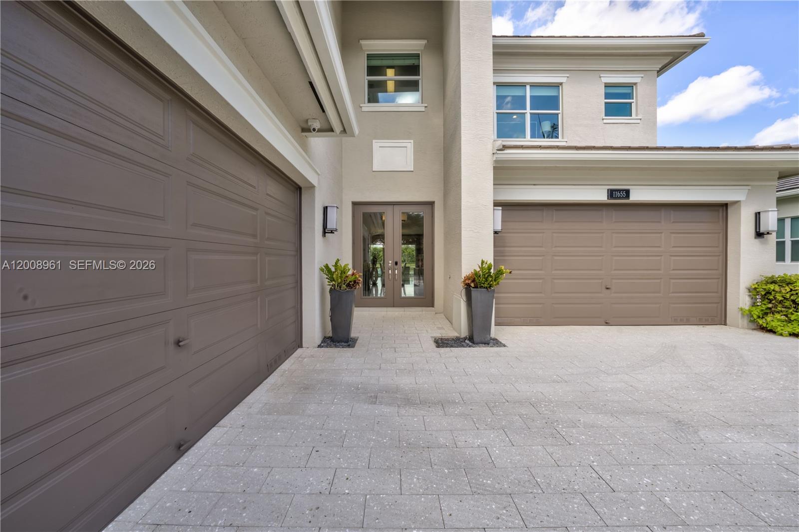 11655 Windy Frst Way Boca Raton, FL 33498 - Photo 6 of 47 a view of a house with garage and plants