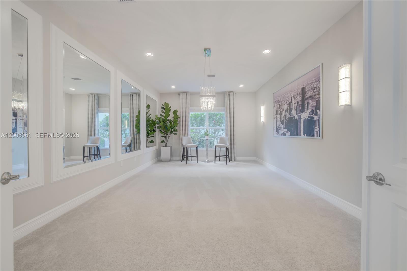 11655 Windy Frst Way Boca Raton, FL 33498 - Photo 7 of 47 a big room with chandelier and windows