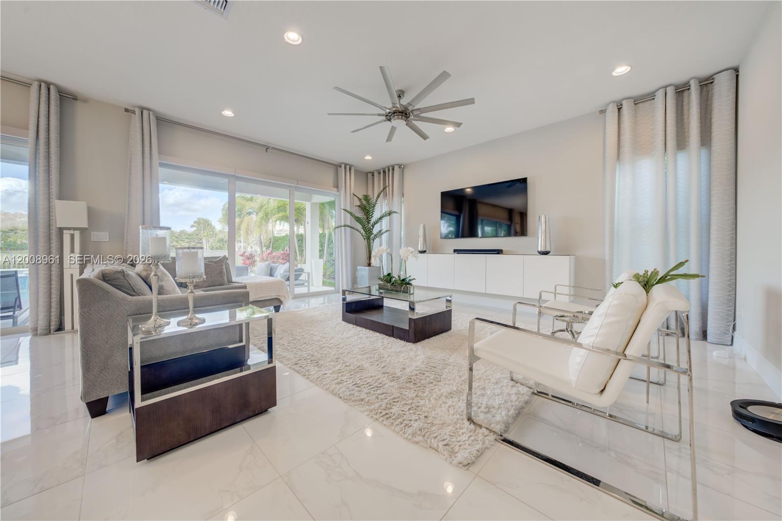 11655 Windy Frst Way Boca Raton, FL 33498 - Photo 9 of 47 a living room with furniture and a flat screen tv