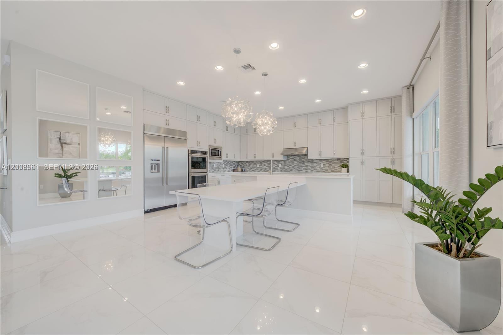 11655 Windy Frst Way Boca Raton, FL 33498 - Photo 10 of 47 a kitchen with white cabinets and stainless steel appliances