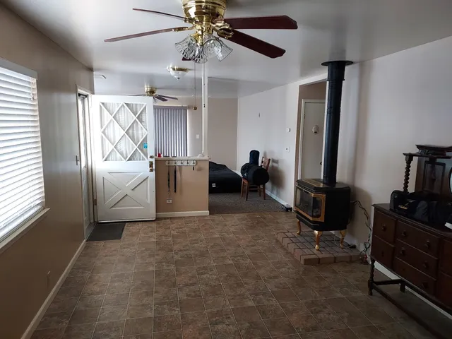 a view of a livingroom with furniture and a window