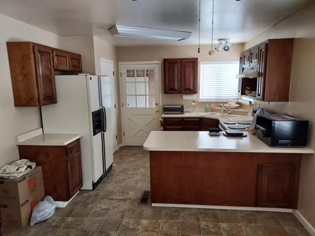 a kitchen with stainless steel appliances granite countertop a sink a stove and a refrigerator