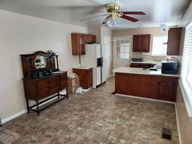 a view of a livingroom with an empty space and a window