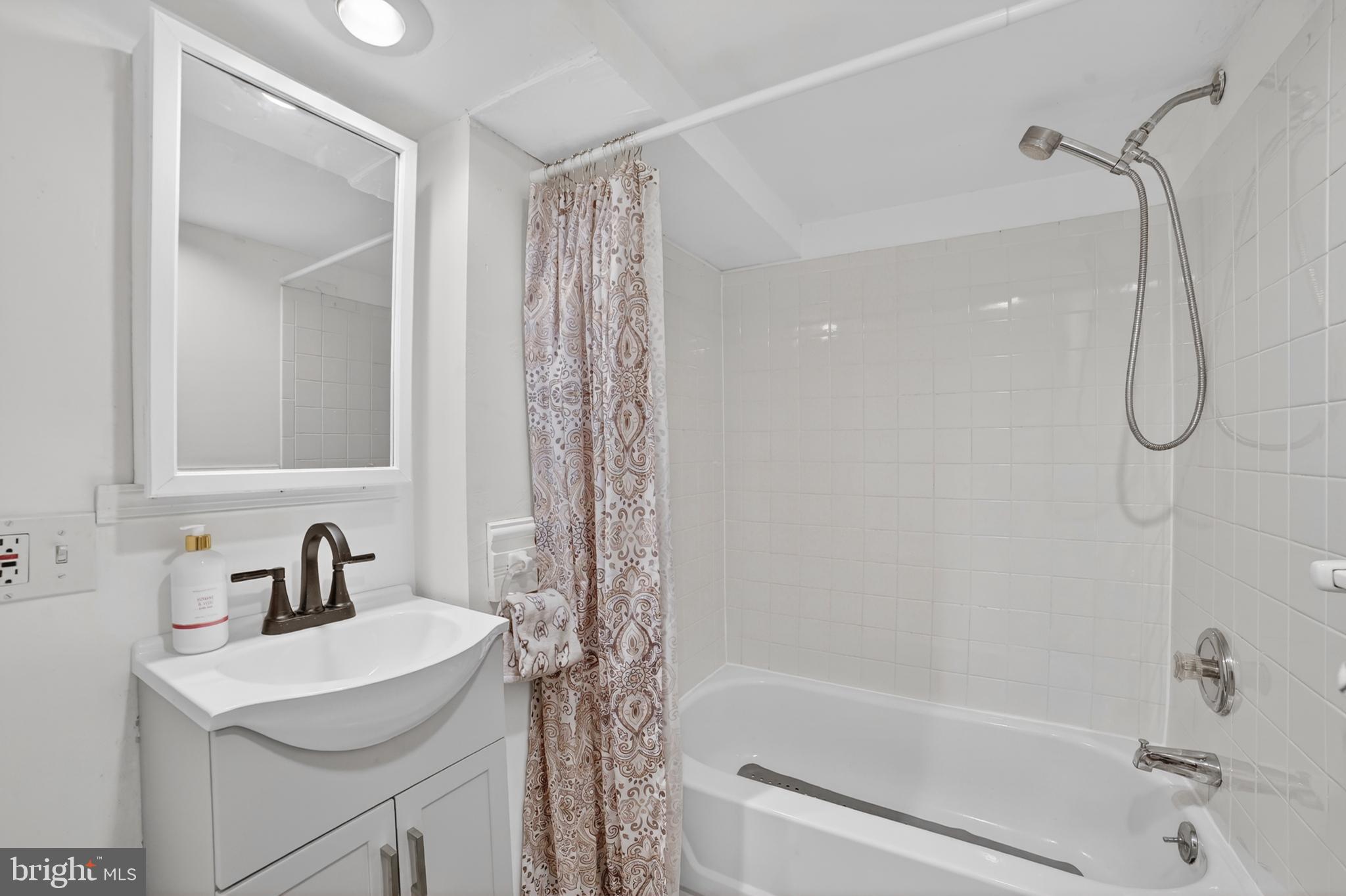 305 Irish Road Berwyn, PA 19312 - Photo 27 of 34 a bathroom with a sink vanity mirror and shower