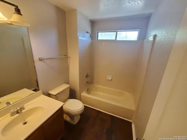a bathroom with a toilet a sink and bathtub