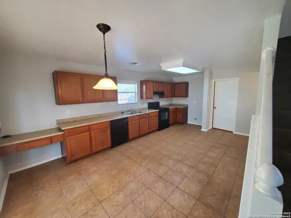 a kitchen with stainless steel appliances granite countertop a sink a stove and a refrigerator