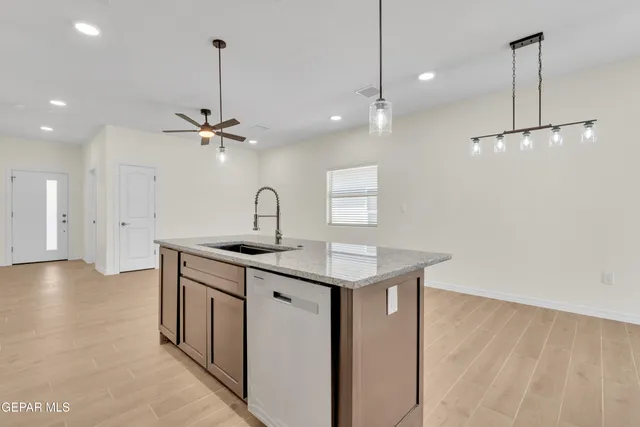 a kitchen with stainless steel appliances kitchen island a refrigerator and a sink