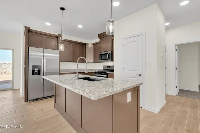 a kitchen with stainless steel appliances granite countertop a stove and a sink