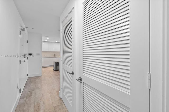 a view of a hallway with washer and dryer