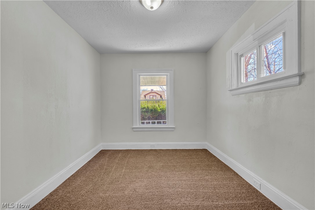 12905 Watterson Avenue Cleveland, OH 44105 - Photo 17 of 30 Carpeted spare room featuring baseboards and a textured ceiling