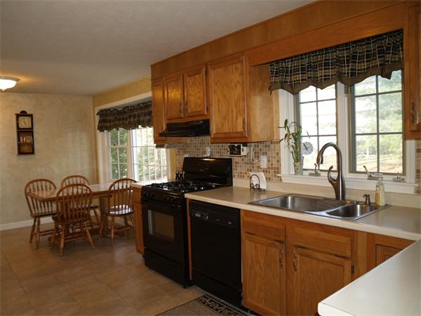 80 Stonegate Road Chelmsford, MA 01824 - Photo 4 of 20 a kitchen with granite countertop a sink stove and cabinets