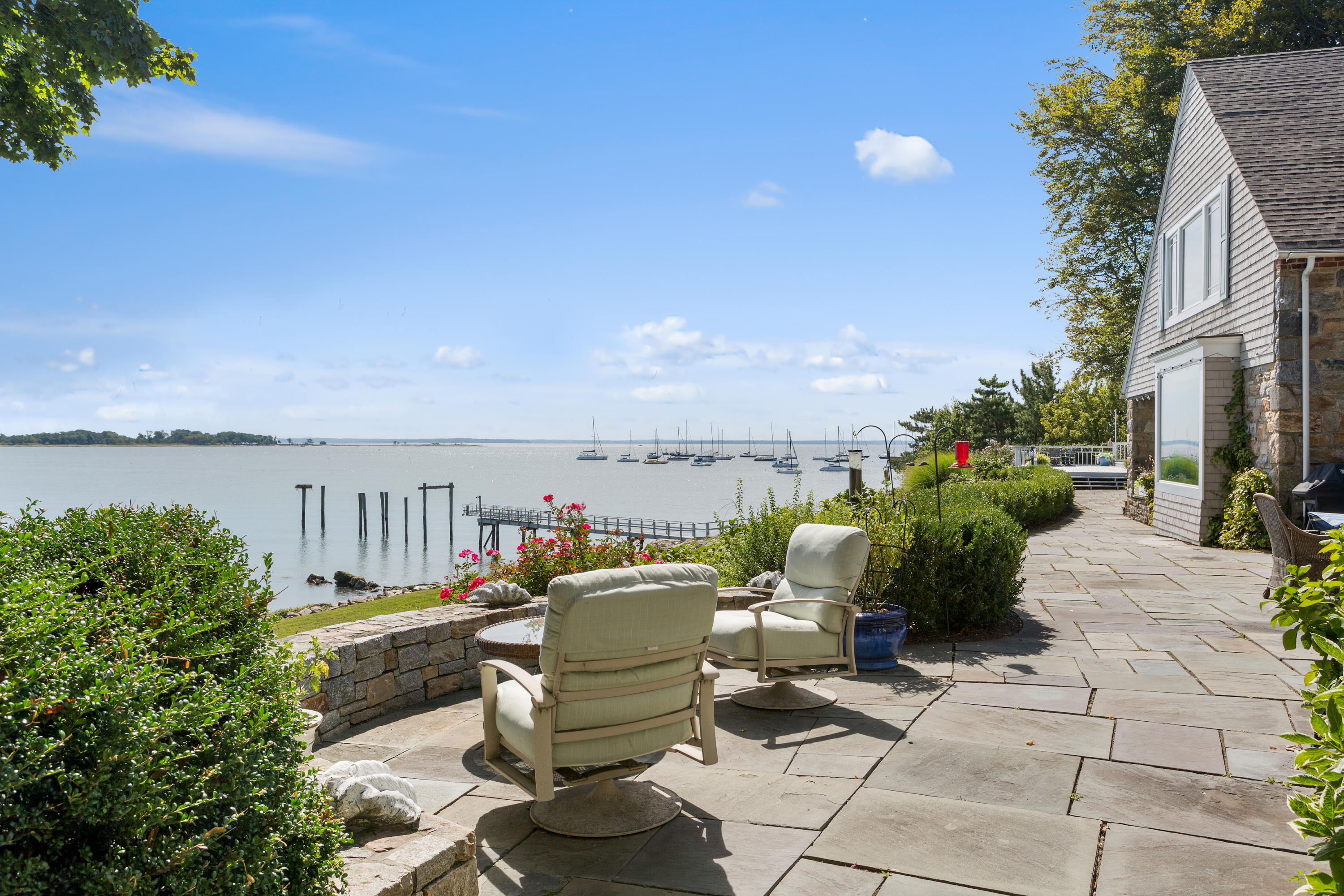 16 Nathan Hale Drive Norwalk, CT 06854 - Photo 24 of 29 a view of a chairs and table in patio with a lake view