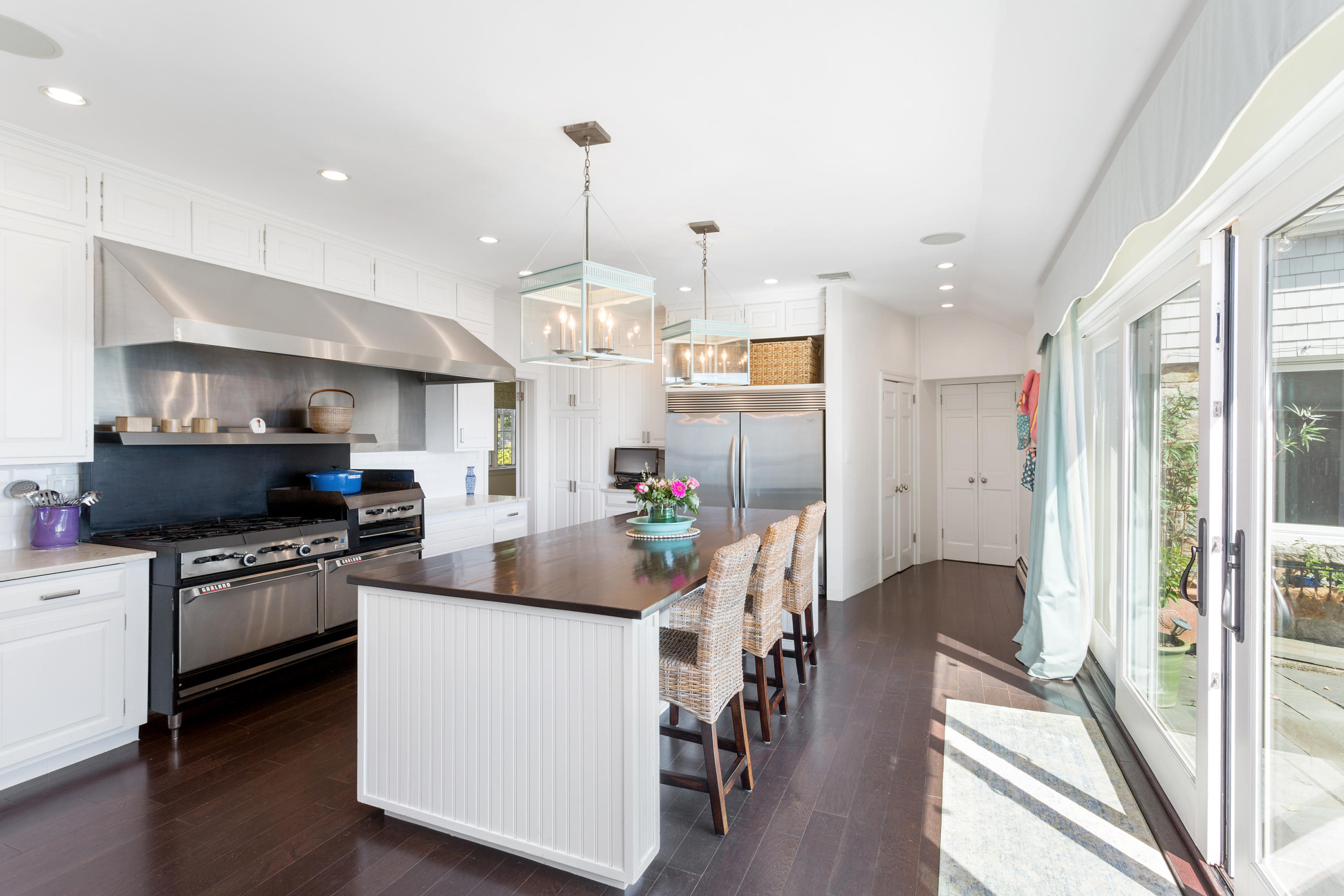 16 Nathan Hale Drive Norwalk, CT 06854 - Photo 7 of 29 a kitchen with stainless steel appliances a stove a sink dishwasher a refrigerator white cabinets and wooden floor next to a window