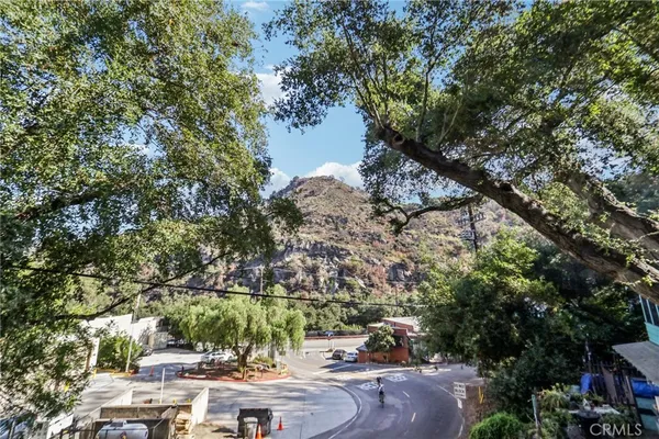 a view of a chair and tables in the balcony