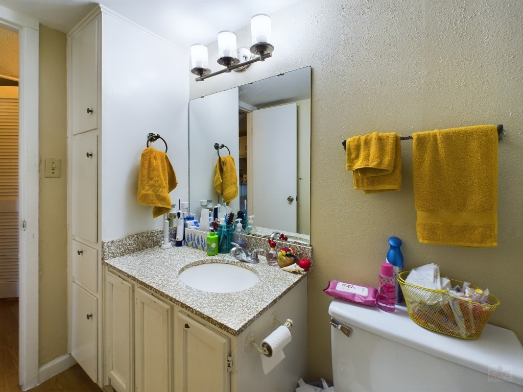 1000 West 26th Street, Unit 118 Austin, TX 78705 - Photo 15 of 18 a bathroom with a granite countertop sink and a mirror
