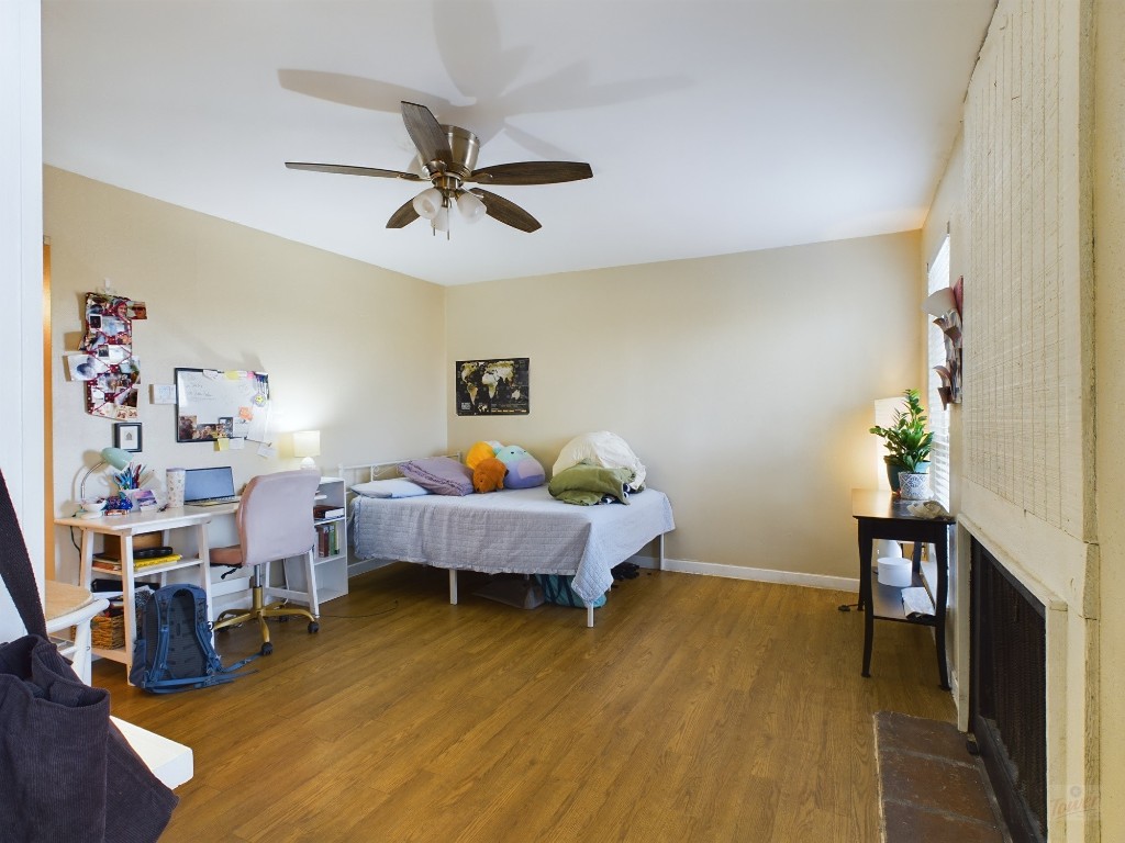 1000 West 26th Street, Unit 118 Austin, TX 78705 - Photo 4 of 18 a living room with furniture and a wooden floor