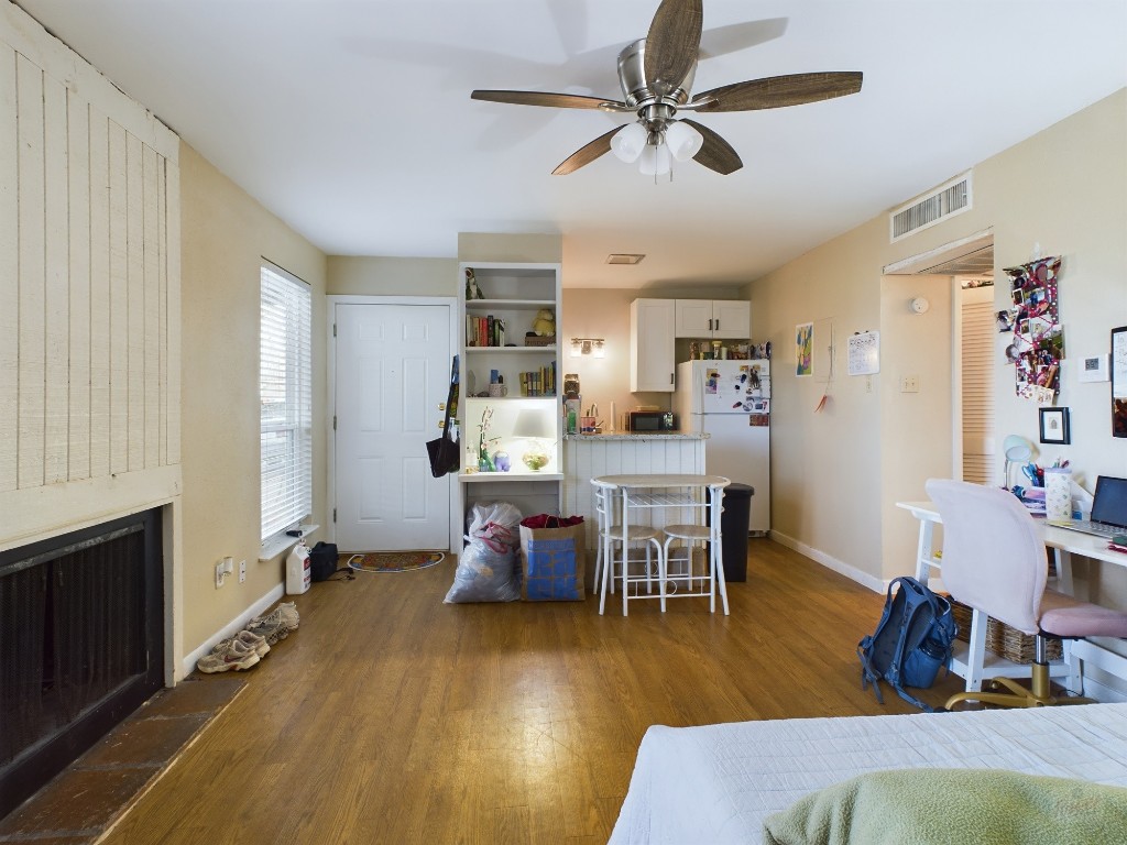 1000 West 26th Street, Unit 118 Austin, TX 78705 - Photo 5 of 18 a living room with furniture and a wooden floor