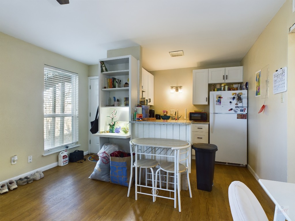 1000 West 26th Street, Unit 118 Austin, TX 78705 - Photo 9 of 18 a living room with furniture and a wooden floor