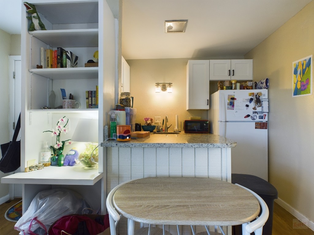 1000 West 26th Street, Unit 118 Austin, TX 78705 - Photo 10 of 18 a kitchen with a table and chairs