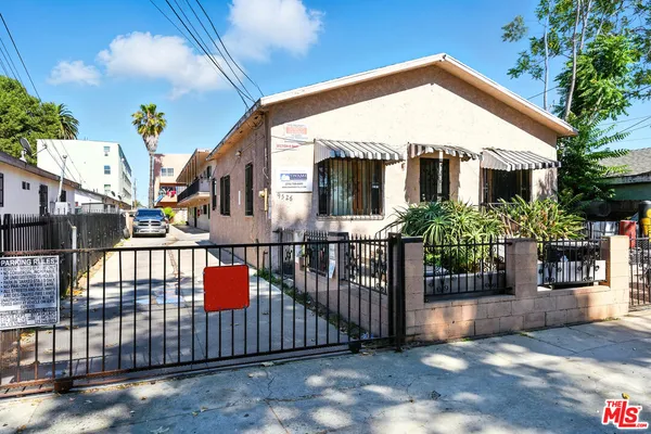 a front view of a house with wooden fence